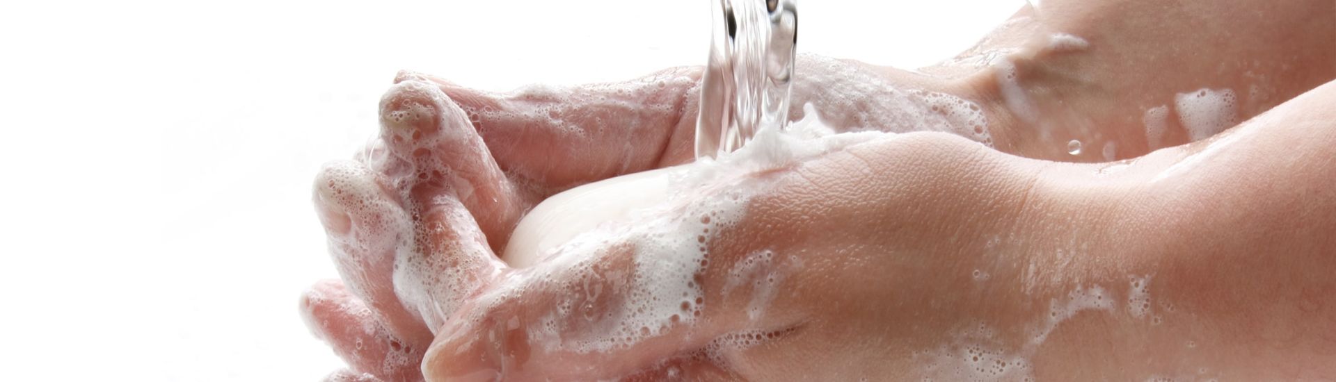 water running into soap in hands